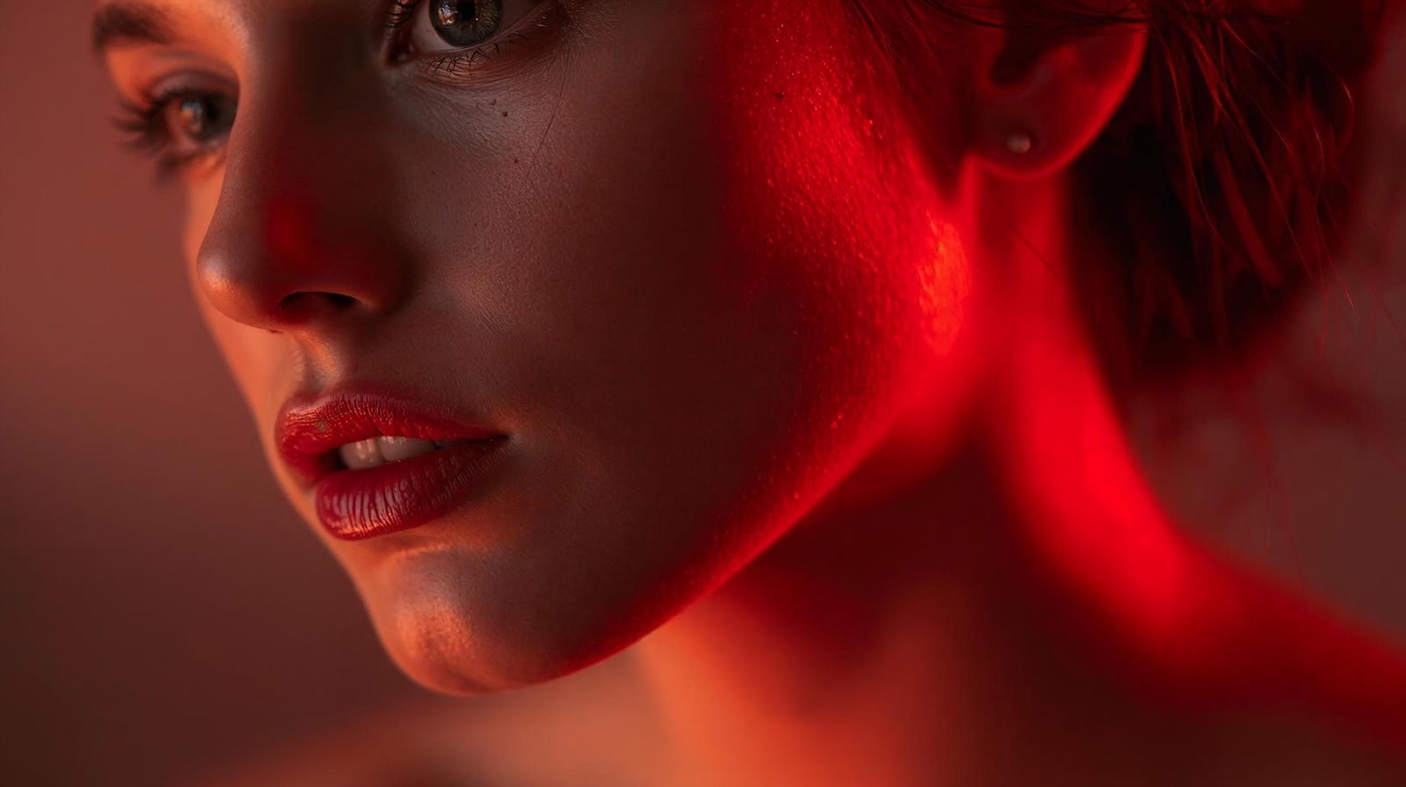 lady with red light reflecting off face neck